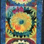 Theme Quilt
First Place
Entered by:	Jean Gilles Dean
	Midland,  TX
Made by:	Jean Gilles Dean
Quilted by: 	Jean Gilles Dean
Pattern by:  Sue Benner
Size: 	17 x 65
How does your garden grow? All in a row.
