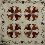 Appliqué Quilt Professional
Third Place
Entered by:	Trudie Fay
	Raton, NM
Made by:	Trudie Fay
Quilted by: 	Trudie Fay
Pattern by:  	Piece of Cake
Pattern Name: Cinnamon Stitches – BOM
Size: 	52.5  x 52.5
Tulip Tango
